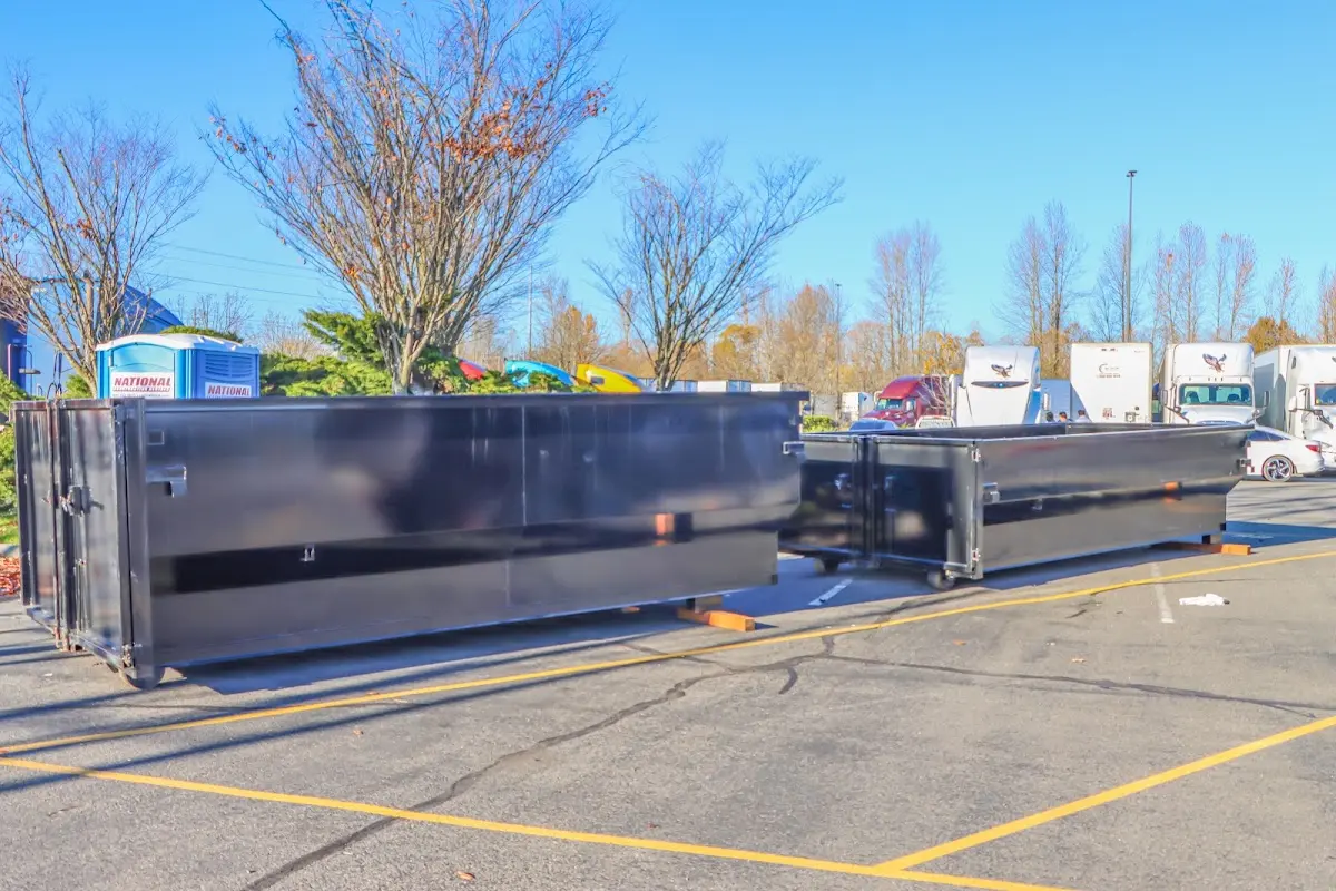 Professional dumpster rental service with roll-off container on residential driveway in Richmond